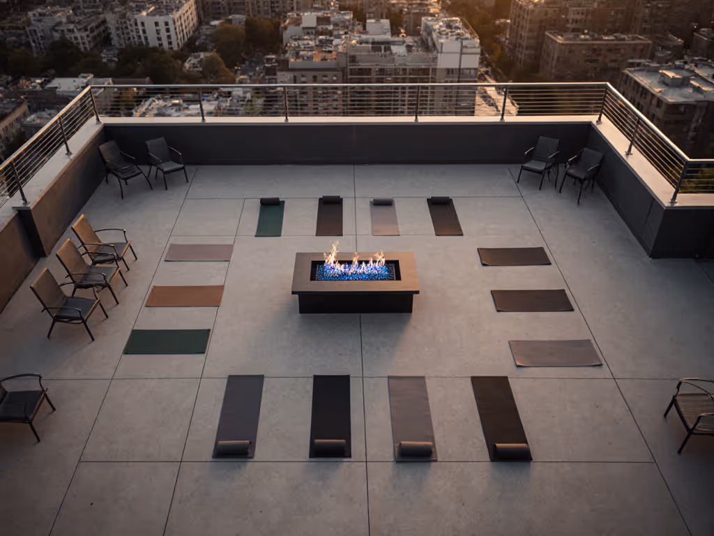 top_down_view_of_rooftop_yoga_setup_with_central_gas_fire_table_and_clear_air_zones